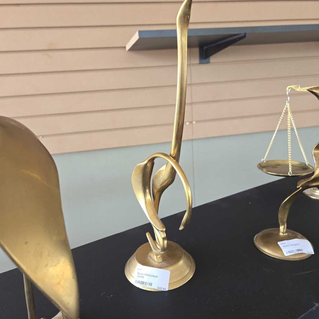 Brass intertwined herons